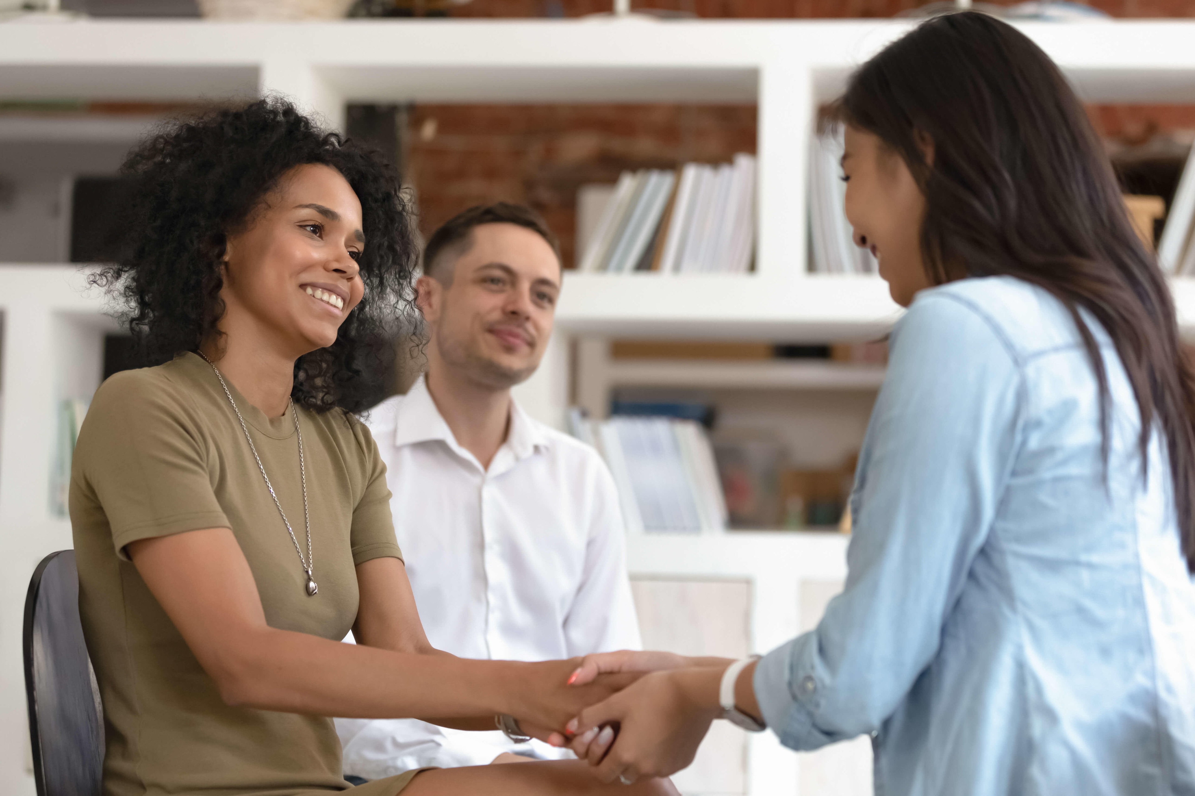 women_holding_hands_during_therapy_session